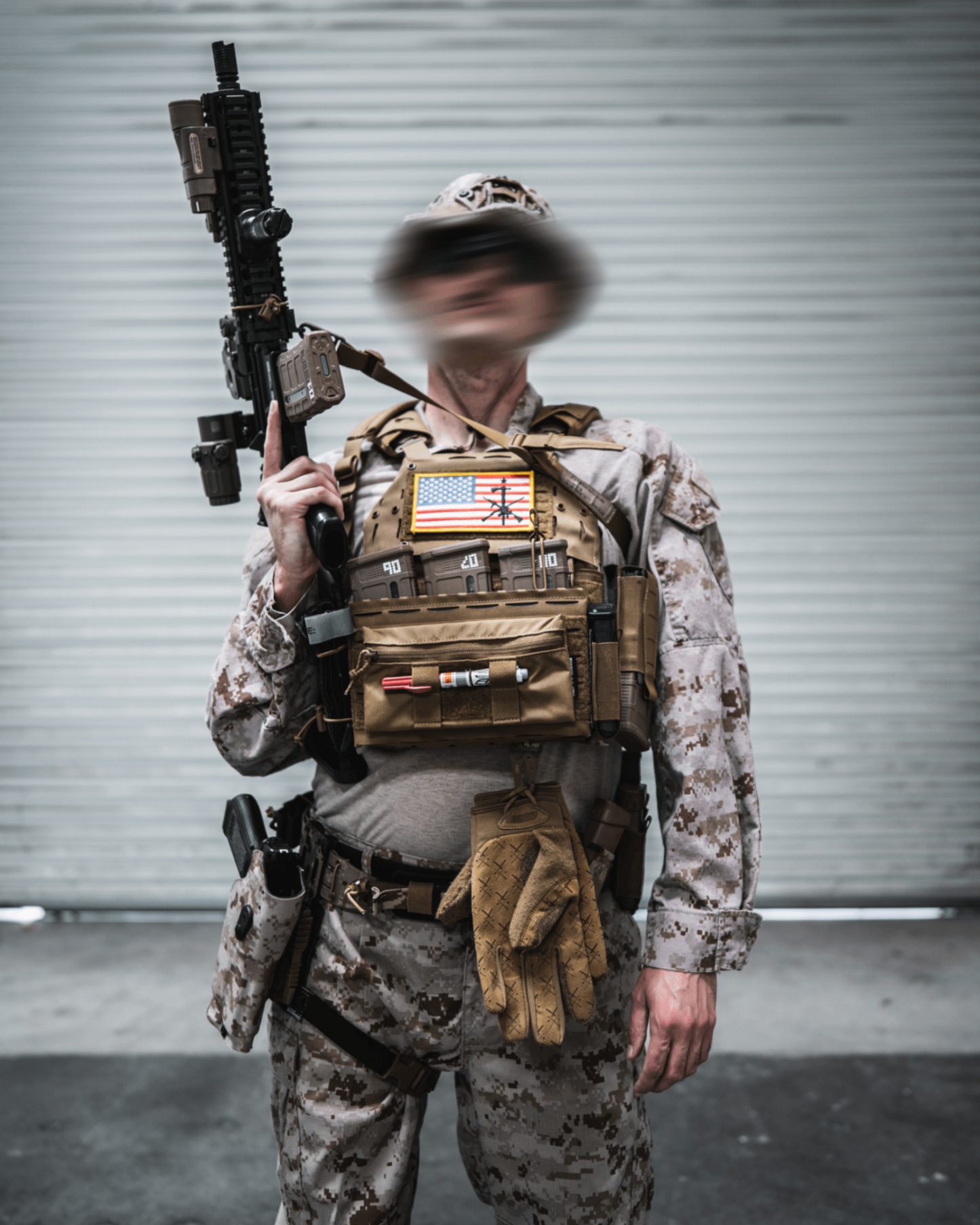 Person in military uniform with gear and weapon against a plain background